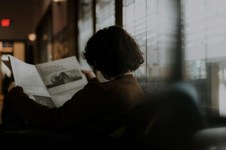 A person reading a newspaper.